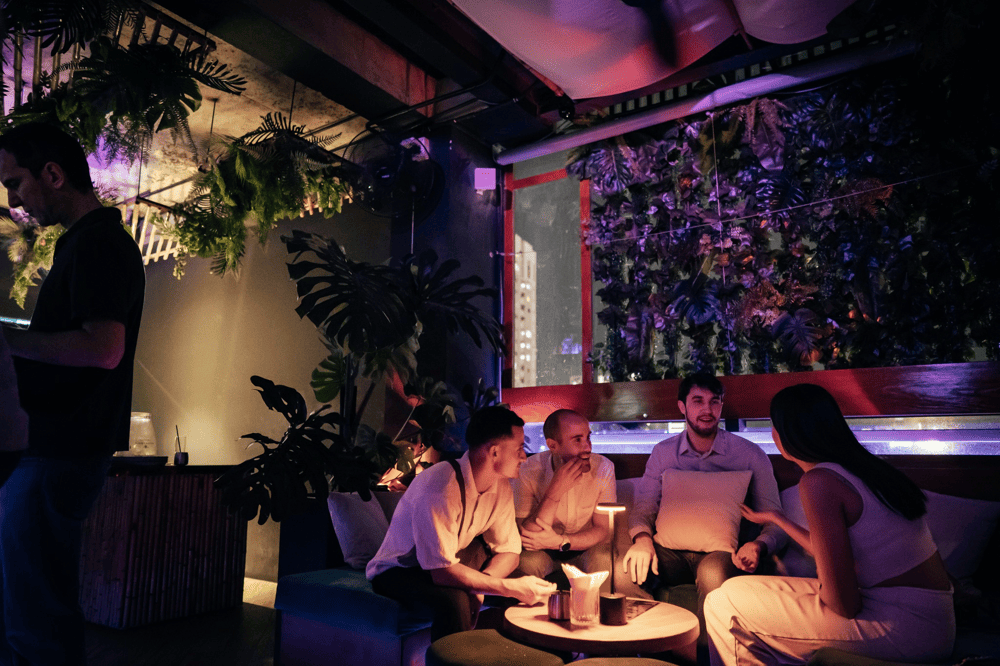 Friends gather under the vibrant sunset, where laughter and cocktails blend into unforgettable moments at Momento (Source: Momento)